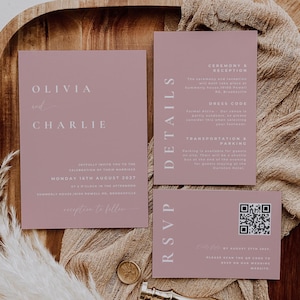 May include: Dusty rose wedding invitation suite with the names Olivia and Charlie, date, time, and location. Includes details and RSVP cards. The suite is on a wooden tray with decorative elements.