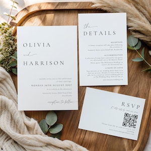 May include: A white wedding invitation suite featuring three rectangular cards with black serif and script typography. The main card reads Olivia and Harrison, the details card lists reception and accommodation info, and the RSVP card includes a QR code.