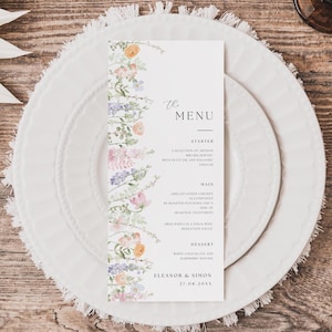Może przedstawiać: Pionowa biała karta menu z akwarelową kwiatową obwódką po lewej stronie z pomarańczowymi, różowymi i fioletowymi kwiatami. Tekst zawiera The Menu, Starter, Main, Dessert oraz Eleanor & Simon 27.08.20XX czcionką szeryfową i skryptową.