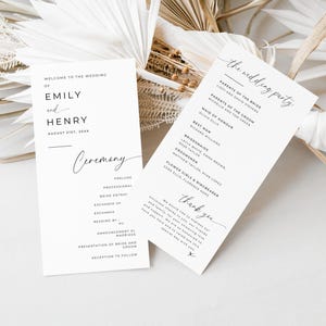 May include: Wedding ceremony program cards with a simple, modern design. The cards are white with black text and include the names of the bride and groom, Emily and Henry, the wedding date, and a list of the wedding party members. The cards also include a section for the ceremony order.