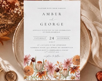 May include: A white wedding invitation card featuring black serif and script text reading Amber and George, Saturday 24 September 2027, and Summerly House, 19100 Powell Rd, Brooksville. The bottom border displays a watercolor illustration of autumn flowers.