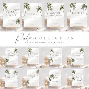 May include: A collection of white wedding table signs with black text and watercolor palm tree illustrations. Signs include phrases like "Sweet Cart," "Favors," "Cards and Gifts," and "Ladies." The signs are displayed on small wooden easels.