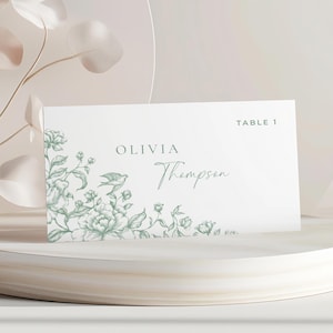 Tarjeta de lugar para boda en toile verde. Tarjeta de lugar para cena en toile de Jouy. Tarjeta de lugar plegada en toile de Jouy. Tarjeta de lugar con flores silvestres estilo chinoiserie. Plantilla editable.