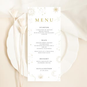 May include: A vertical white menu card featuring gold celestial illustrations of suns, moons, and constellations. The text reads MENU, STARTER, MAIN, DESSERT, and includes food items like grilled lemon chicken, ending with OLIVIA & MATTHEW 27.08.20XX.
