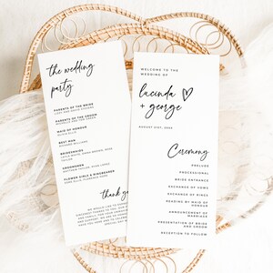 May include: Two white wedding programs with black calligraphy text, including the wedding party details and ceremony schedule. The programs are in a woven basket, creating a rustic aesthetic.