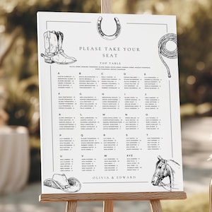 May include: A white wedding seating chart with a western theme. The chart features illustrations of a cowboy boot, horseshoe, rope, cowboy hat, and a horse head. The text reads "PLEASE TAKE YOUR SEAT" and lists names under alphabetical headings.