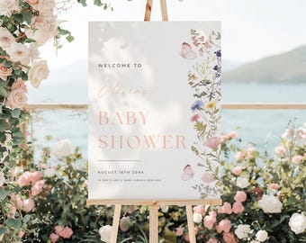 May include: Welcome to Olivia's Baby Shower sign with a floral design and butterflies. The sign says "August 16th 20XX" and "12 Days Until Baby Adams Arrives!"