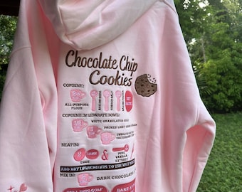 Sudadera con capucha bordada con receta de galletas con chispas de chocolate rosa claro