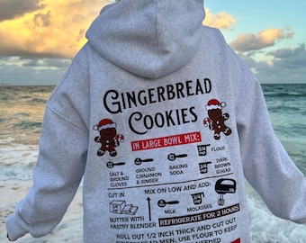 Sudadera con capucha bordada navideña con receta de pan de jengibre color marfil