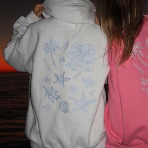 Moletom com capuz bordado tropical cinza pérola