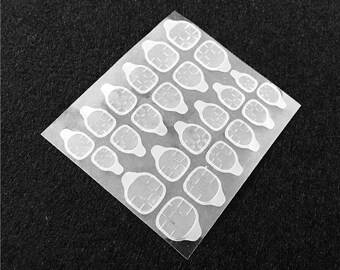 May include: A sheet of clear, adhesive nail stickers. Each sticker is a rounded square shape with a grid pattern, designed to fit various nail sizes. The stickers are arranged on a transparent backing, ready for application.