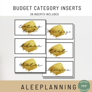 May include: A set of 39 printable budget category inserts with gold foil accents. The inserts feature handwritten text on a white background. The text includes categories such as "Eating Out", "Mortgage", "Phone", "Rent", "Water", and "Groceries".