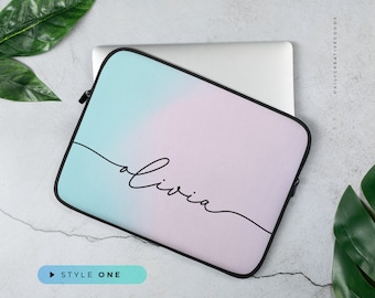 May include: A pink and blue ombre laptop sleeve with the name "Olivia" written in cursive on the front.