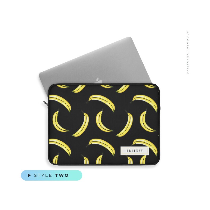 May include: Black laptop sleeve with a yellow banana pattern. The sleeve has a zipper and a black label with the text "BRITNEY" on it.
