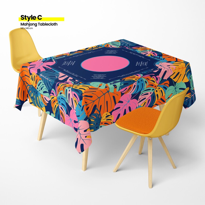 May include: A vibrant Mahjong tablecloth with a tropical leaf pattern in shades of orange, pink, blue, and green. The tablecloth is rectangular, covering a table with two yellow chairs and one orange chair. The tablecloth measures 55 x 55 inches.