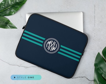 May include: A navy blue laptop sleeve with three teal stripes and a white rope circle monogram. The monogram has the letters "MXW" inside.