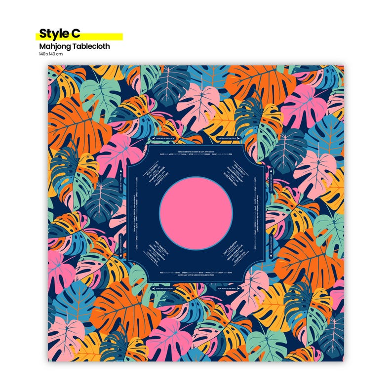 May include: A Mahjong tablecloth with a vibrant tropical leaf pattern in orange, pink, blue, and yellow. The center features a dark blue square with a pink circle. The tablecloth measures 55 x 55 inches.