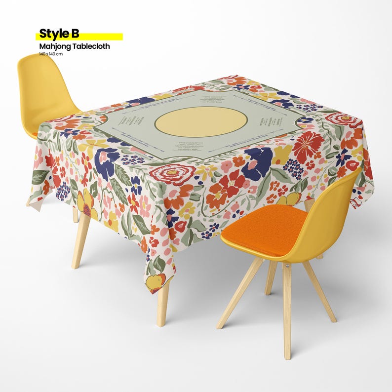May include: A floral Mahjong tablecloth, 55 x 55 inches, covers a table. The tablecloth features a cream background with red, blue, and yellow flowers. Two yellow chairs with wooden legs and an orange seat cushion are positioned around the table. The text "Style B Mahjong Tablecloth" is in the upper left corner.