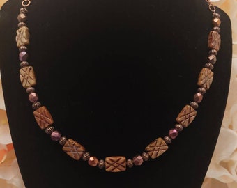 Monochromatic necklace with brown rectangle and copper beads with copper chain and toggle clasp