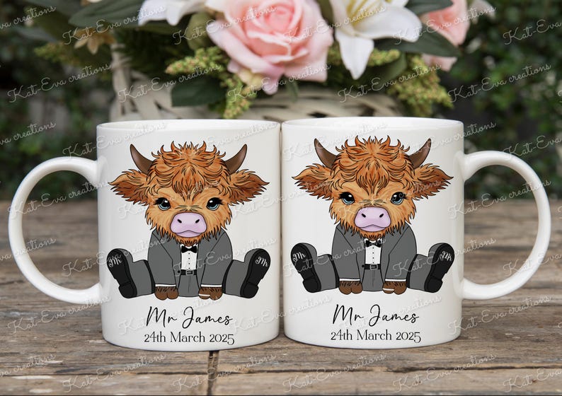 May include: Two white ceramic mugs with a cartoon illustration of a Highland cow wearing a tuxedo. The mugs have the text "Mr. James" and "24th March 2025" printed on them.