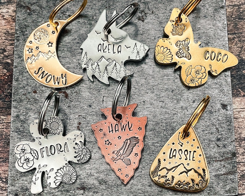 cute pet id tags in various shapes: moon, wolf head, butterfly, shamrock, arrowhead, guitar pick