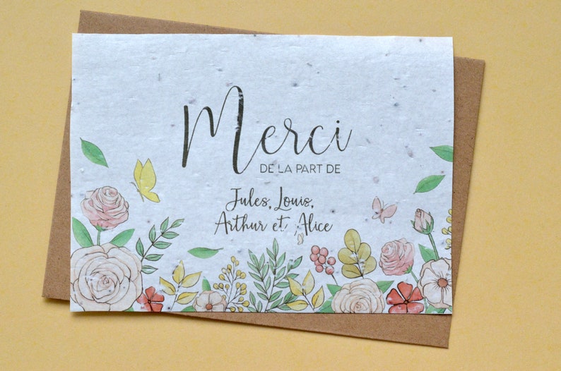 May include: A white card with a floral border and the text 'Merci de la part de Jules, Louis, Arthur et Alice'.