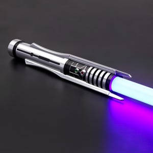 May include: A silver lightsaber with a black and silver handle and a purple blade. The lightsaber is turned on and the blade is glowing.
