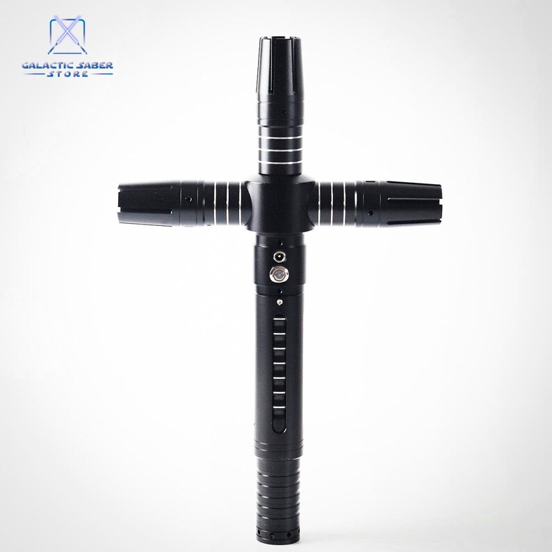 Puede incluir: Un sable de luz negro con guarda cruzada y detalles plateados. El mango presenta l&iacute;neas verticales y un bot&oacute;n. El logotipo de Galactic Saber Store est&aacute; en la esquina superior izquierda. El sable de luz tiene cuatro hojas.