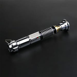 May include: A disassembled silver lightsaber with a black and silver handle, a green and red light, and a gold and silver connector.