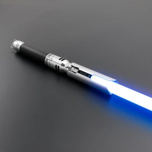 May include: A silver lightsaber with a black handle and a blue blade. The lightsaber is switched on and the blade is glowing.