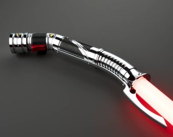 May include: A silver lightsaber with a black and silver handle and a red blade. The lightsaber is turned on and the blade is glowing.