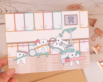 May include: A greeting card featuring a dental office scene with cartoon teeth characters. The illustration includes a dental chair, tools, and a framed tooth image. The color palette includes pastel pink, blue, and green.