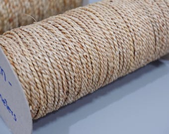 May include: Close-up of a spool of natural-colored rope. The rope is tightly wound, showing a textured, braided pattern. The spool's side has text indicating the rope's dimensions. Ideal for crafting and decorative projects.