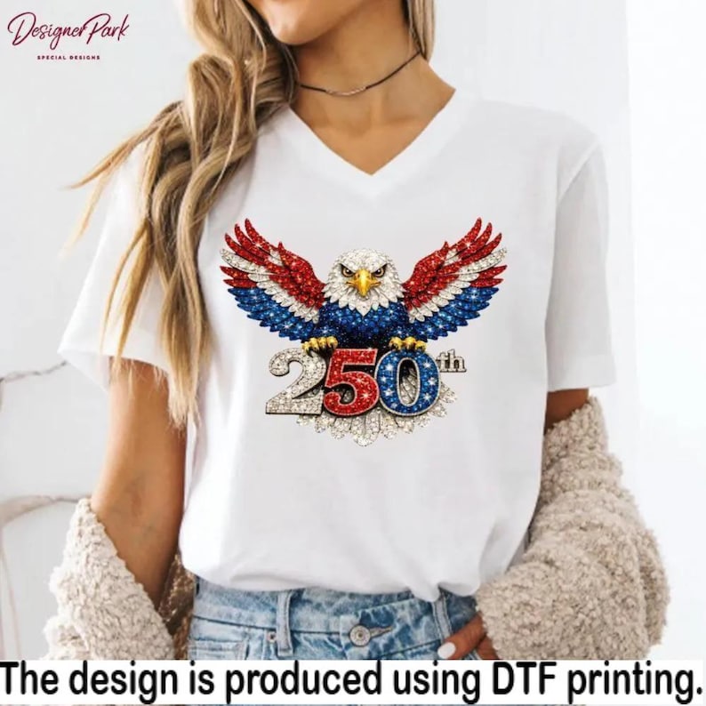 A woman wearing a white t-shirt with a graphic design of an eagle holding a flag with the number "250" on it.