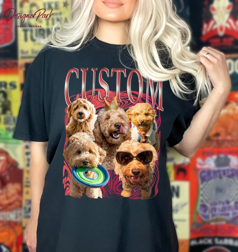 A woman wearing a black t-shirt with a graphic design featuring a group of dogs, including a golden retriever, a poodle, and a dachshund, along with a frisbee.