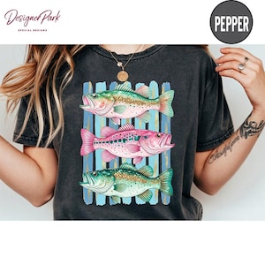 A person wearing a black t-shirt with a colorful graphic of three fish.