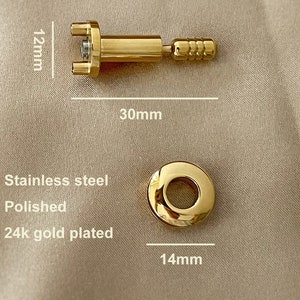 May include: A gold-plated, polished stainless steel  eyeglass screw with a 12 mm length and 30 mm diameter. The screw has a round head with a 14 mm diameter.
