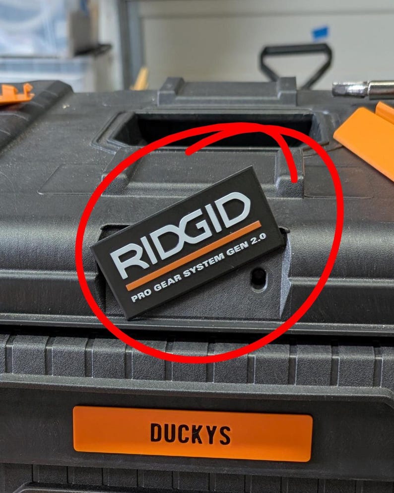 May include: Black toolbox with the brand name "RIDGID" and "PRO GEAR SYSTEM GEN 2.0" printed on a black and orange label. The toolbox also has an orange label that says "DUCKYS".