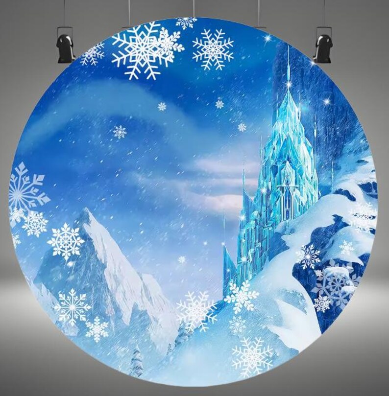 May include: A blue and white backdrop featuring a large ice castle with snow-covered mountains and snowflakes. The castle is made of ice and has a pointed roof. The mountains are covered in snow and have a white, fluffy texture. The snowflakes are scattered throughout the image and are white and blue.