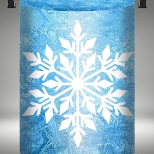 May include: A blue cylinder with a white snowflake design. The cylinder has a frosted glass look.