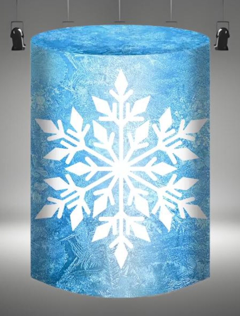 May include: A blue cylinder with a white snowflake design. The cylinder has a frosted glass look.