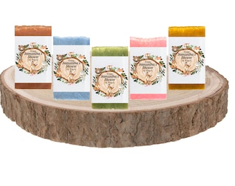 May include: Five small bars of soap with woodland animal designs and the text "From Samantha's Shower to Yours" on each bar. The bars are arranged on a wooden slice.