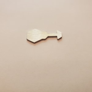 May include: A silver-colored metal key with a hexagonal head and a straight arrow-shaped handle.