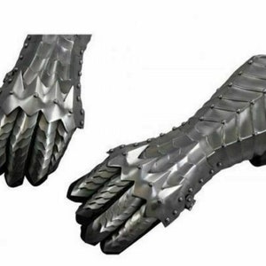 May include: A pair of silver metal gauntlets with a dragon scale design. The gauntlets are fully articulated and have a claw-like design on the fingers.