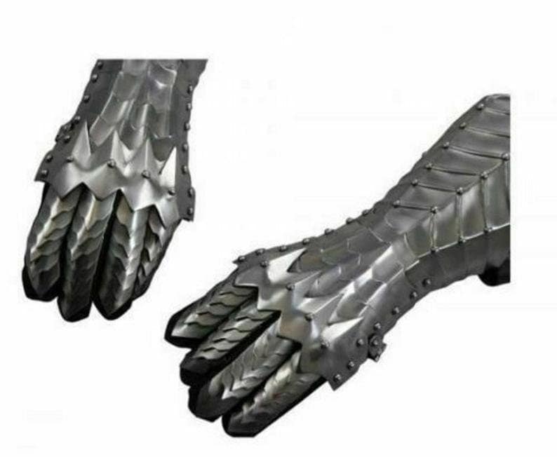 May include: A pair of silver metal gauntlets with a dragon scale design. The gauntlets are fully articulated and have a claw-like design on the fingers.