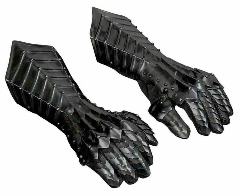 May include: A pair of black metal gauntlets with a scaly design. The gauntlets are made of interlocking metal plates and have a pointed finger design.