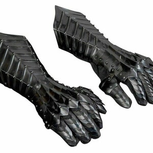 May include: A pair of black metal gauntlets with a scaly design. The gauntlets are fully articulated and have a pointed design on the fingers.