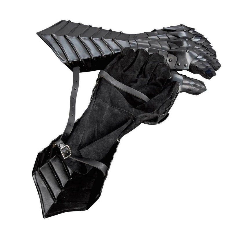 May include: Black leather gauntlets with metal plates and finger guards. The gauntlets are designed to protect the hands and forearms during combat.