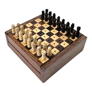 May include: A wooden chess set with a brown and black checkered board and wooden pieces. The set is closed and the pieces are in place on the board.