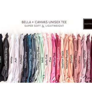 May include: A Bella + Canvas unisex tee shirt in 18 different colours, including black, white, heather grey, ash, athletic heather, navy heather, deep teal heather, slate heather, dusty blue heather, mint, soft pink, pink, charity pink, raspberry heather, peach heather, sunset heather, sunset, mauve heather, mauve, orchid heather, maroon, and maroon. The text "SUPER SOFT & LIGHTWEIGHT" and "BELLA + CANVAS UNISEX TEE" is displayed above the shirts. The text "ELLEYTEES" is displayed in a circle in the top right corner of the image.